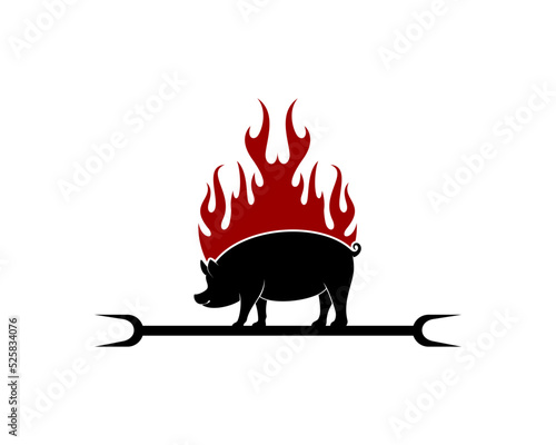 Pig silhouette with barbeque stick and fire behind