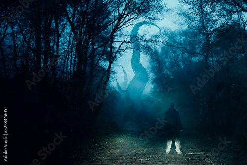A horror concept of a man watching a Cthulhu monster with tentacles. Appearing out of the fog on a spooky winter forest at night.