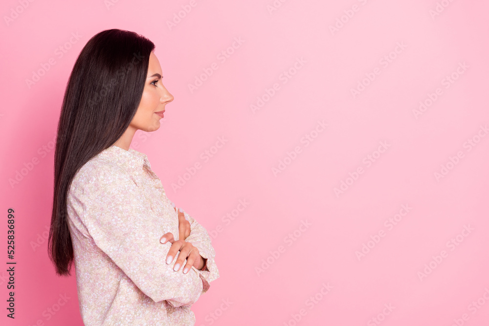 Side profile photo of young attractive boss lady crossed hands confident looking empty space isolated on pink color background Side profile photo of young attractive boss lady crossed hands confident looking empty space isolated on pink color background
