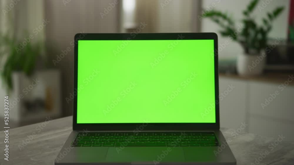 Slow optical zoom in into a laptop computer screen with a green screen on it Slow optical zoom in into a laptop computer screen with a green screen on it