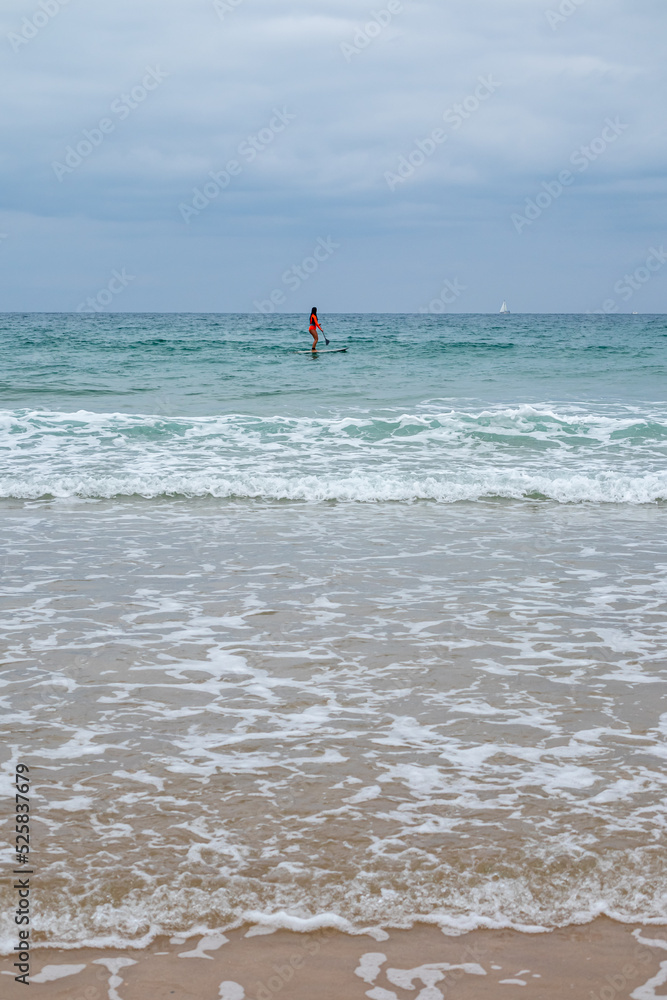 students learning to surf at La Barrosa beach in Sancti Petri, Cadiz, Spain