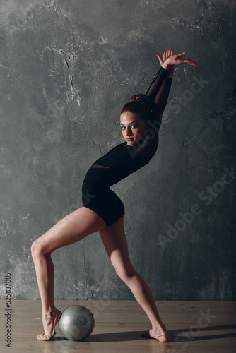 Young girl professional gymnast woman dance rhythmic gymnastics with ball at studio.