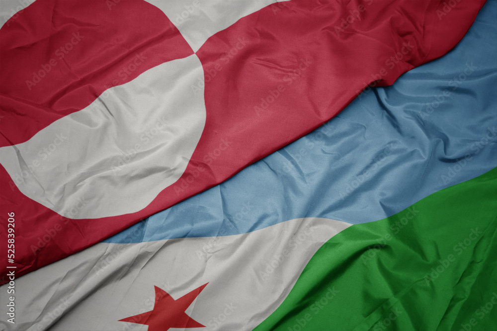 waving colorful flag of djibouti and national flag of greenland.