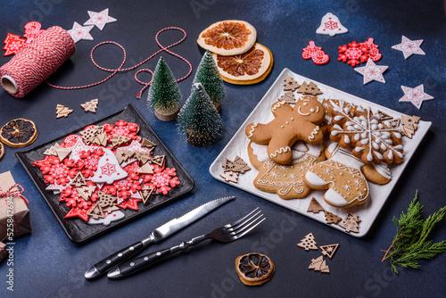 Fototapeta Naklejka Na Ścianę i Meble -  Christmas decorations and gingerbreads on a dark concrete table. Getting ready to celebration