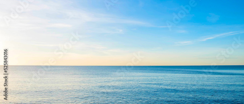 The view of the sea in the morning with the golden rays of the sun shining on the sea in summer