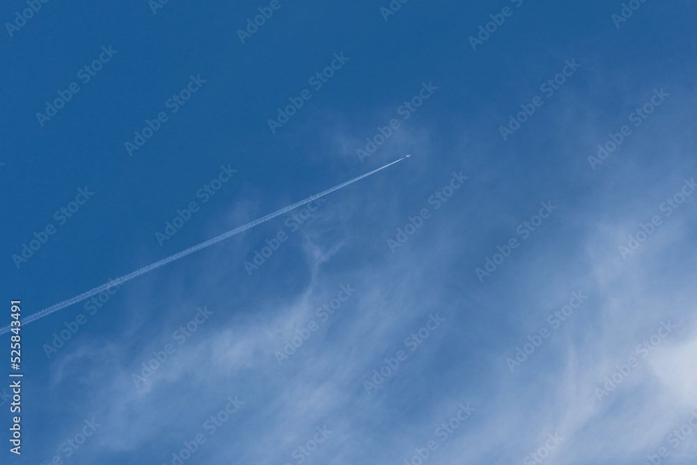 A plane in the sky leaves a white trail, a beautiful sky with clouds, a dream of traveling A plane in the sky leaves a white trail, a beautiful sky with clouds, a dream of traveling