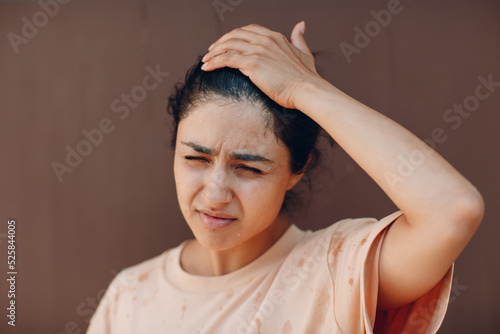 Stressed woman suffering of heatstroke refreshing with cold water outside. Weather abnormal exreme heat concept photo