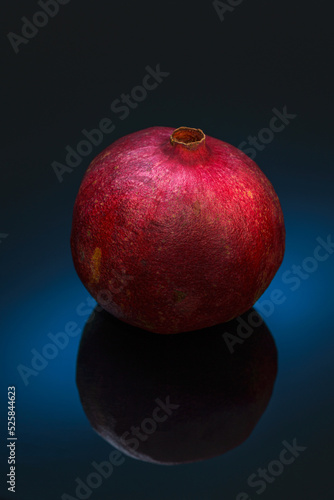 Still life with red pomegranat on the black background