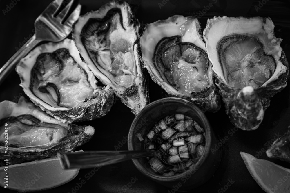 Fresh oyster platter served with classic sauce. Black white