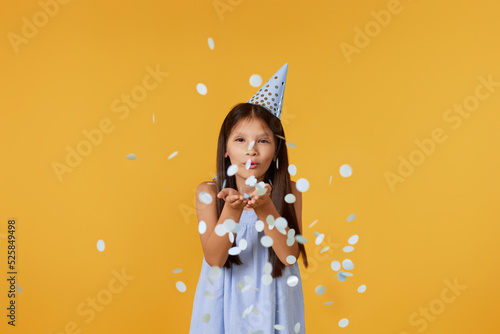 birthday child girl blowing confetti off her hands