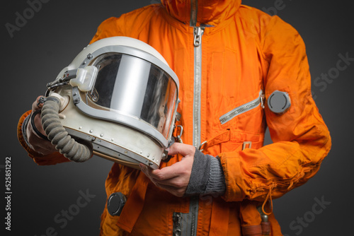 Fotografie Space helmet in the astronaut hands close up