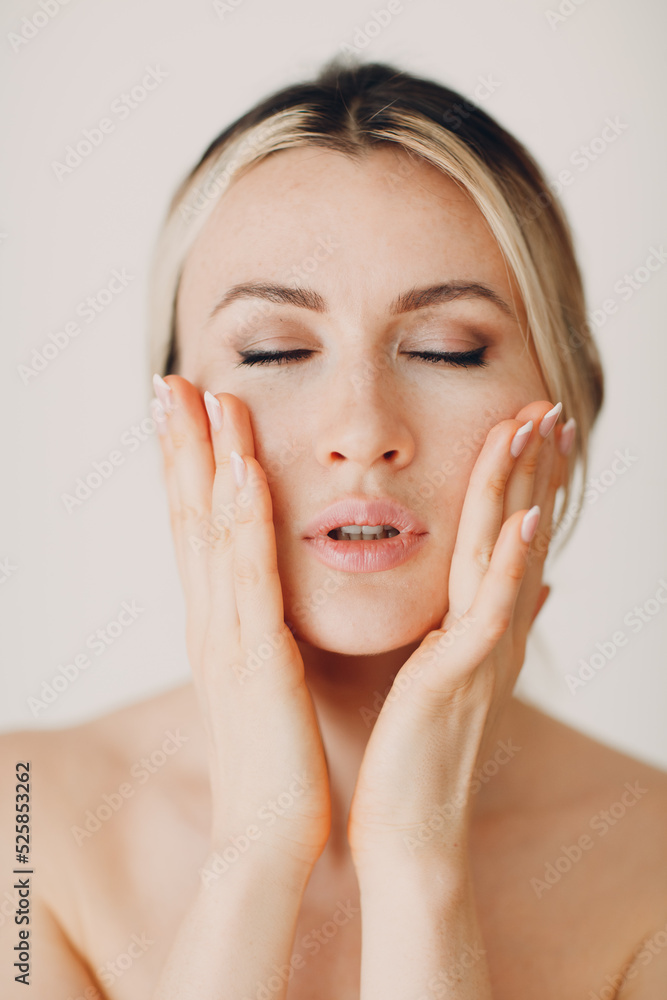 Young adult doing facial gymnastics self massage and rejuvenating exercises face building and lifting Young adult doing facial gymnastics self massage and rejuvenating exercises face building and lifting