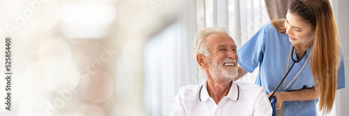 Web banner Man being cared for by a private Asian nurse at home suffering from Alzheimer's disease to closely care for elderly patients with copy space on left
