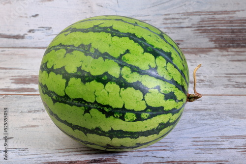 Fresh whole watermelon composition on wooden background.