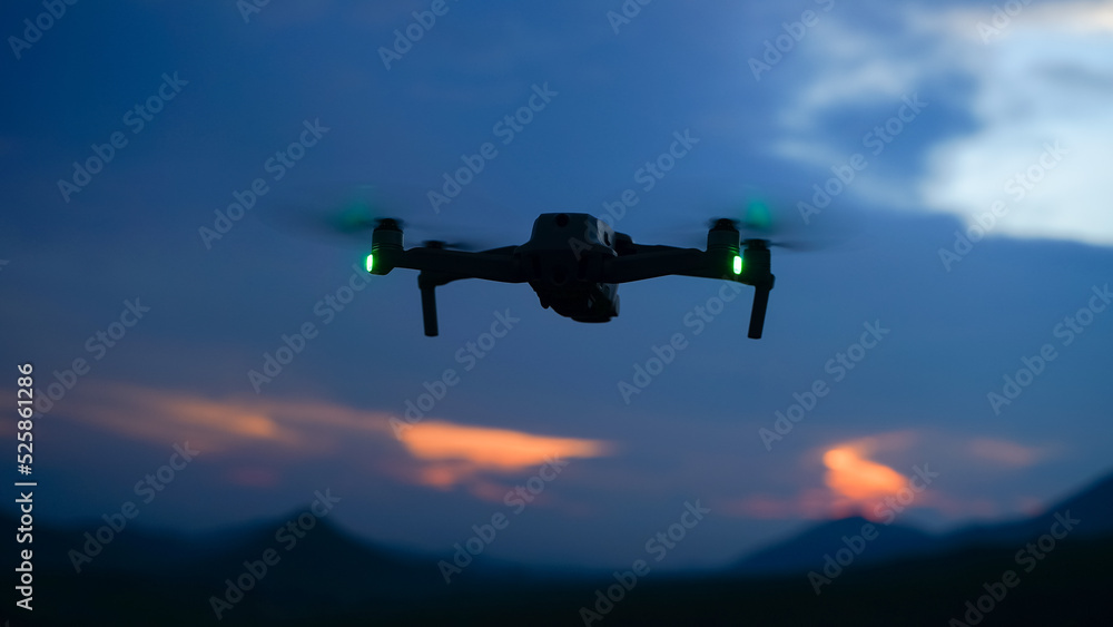Silhouette of a drone during the sunset or sunrise, unmanned aerial vehicle in the outdoor Silhouette of a drone during the sunset or sunrise, unmanned aerial vehicle in the outdoor