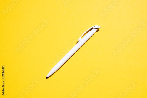 white pen in the center on a yellow background