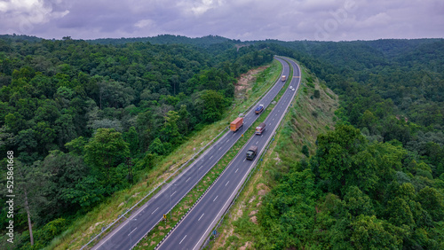 Aerial view of road going through greenery, Roads through the green forest, drone landscape