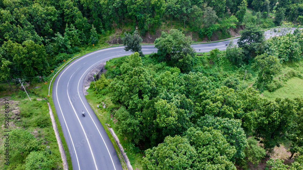 Aerial view of road going through greenery, Roads through the green forest, drone landscape Aerial view of road going through greenery, Roads through the green forest, drone landscape