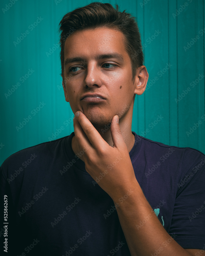 teal and orange portrait of a man. close-up portrait of a young guy.guy in a thoughtful pose. man makes a decision teal and orange portrait of a man. close-up portrait of a young guy.guy in a thoughtful pose. man makes a decision