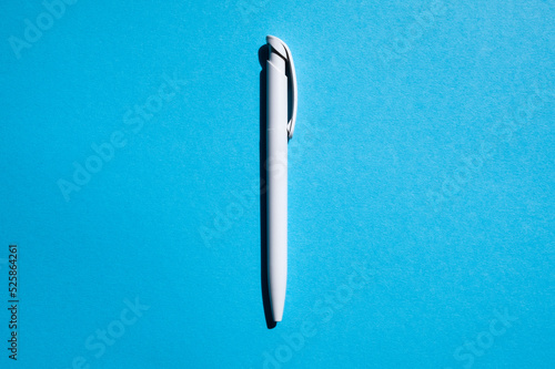 white pen in the center on a blue background