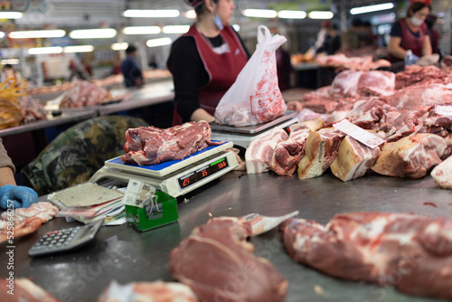 Meat sale on shopwindow at european butcher market counter scales.
