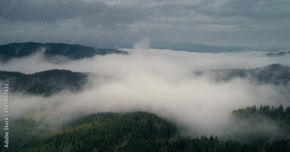 Aerial view of beautiful nature landscape drone flies over mountain forest and low clouds. Epic scenery on travel vacation. Aerial view of beautiful nature landscape drone flies over mountain forest and low clouds. Epic scenery on travel vacation.