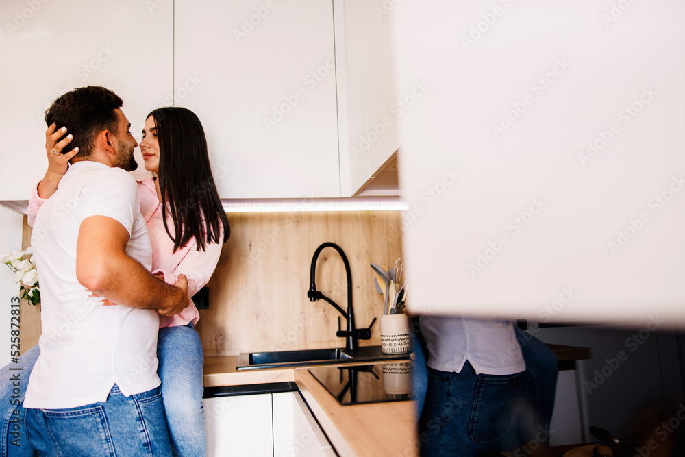 Happy couple in love standing in the kitchen romantically. Big love in their eyes. Happy couple in love standing in the kitchen romantically. Big love in their eyes.