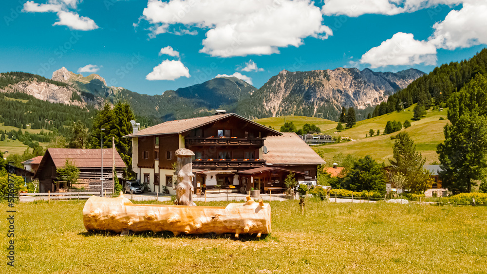 Beautiful alpine summer view with a wooden drinking water fountain at the famous Tannheimer Tal valley, Tannheim, Tyrol, Austria