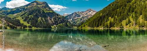 High resolution stitched panorama with reflections at the famous Vilsalpsee, Tannheimer Tal valley, Tyrol, Austria