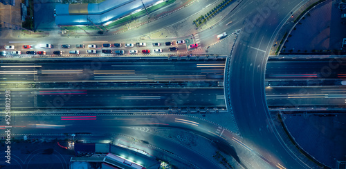 Expressway top view, Road traffic an important infrastructure,car traffic transportation above intersection road in city night, aerial view cityscape of advanced innovation, financial technology 