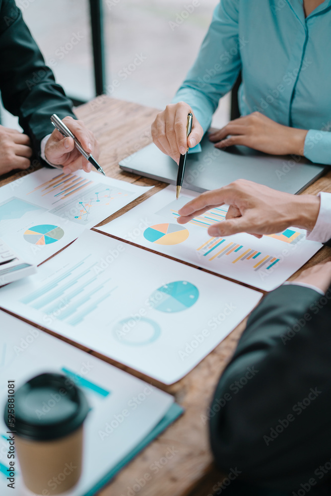 Group of business people meeting together Pointing to the graph assess business profits Group of business people meeting together Pointing to the graph assess business profits