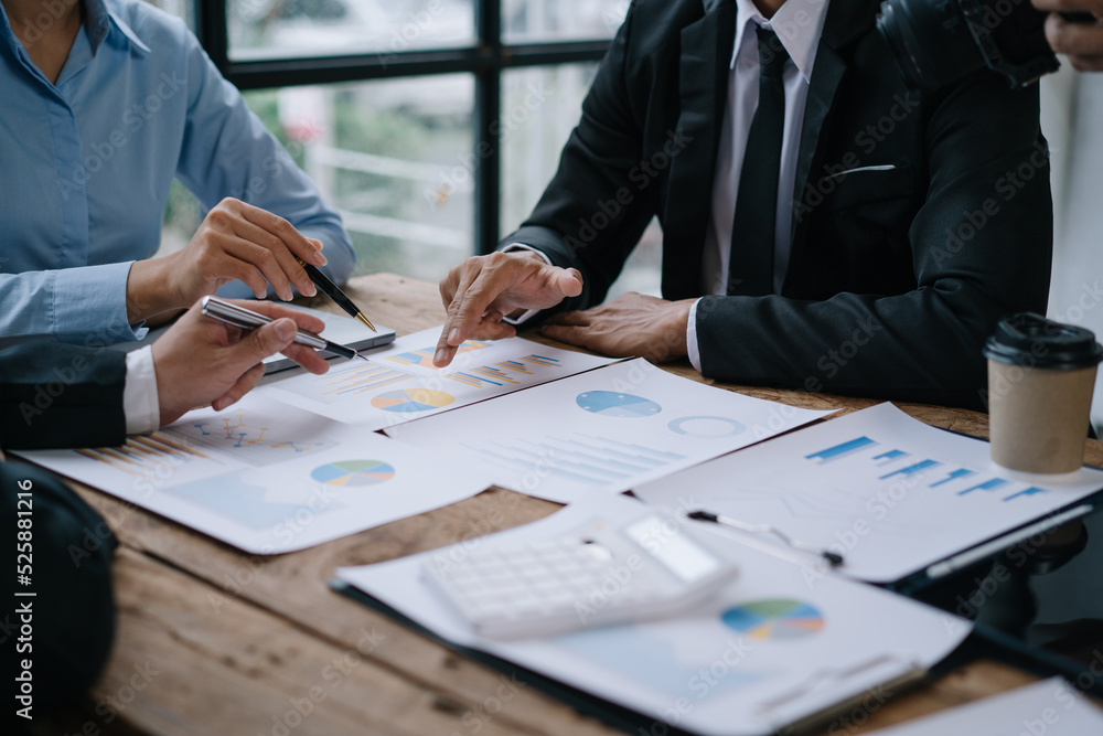 Group of business people meeting together Pointing to the graph assess business profits Group of business people meeting together Pointing to the graph assess business profits