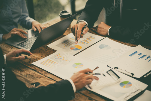 Obraz na plátně Group of business people meeting together Pointing to the graph assess business