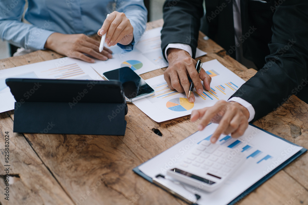 Group of business people meeting together Pointing to the graph assess business profits Group of business people meeting together Pointing to the graph assess business profits