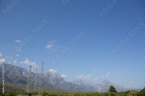 Telecommunication antenna tansmitter tower at mountains background