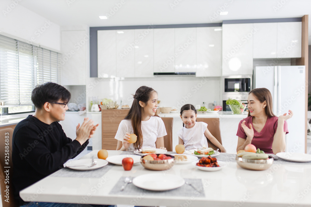 Happy Asian family dining at home. families enjoy together at home while having a meal at dining table. Happy Asian family dining at home. families enjoy together at home while having a meal at dining table.