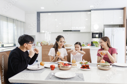 Happy Asian family dining at home. families enjoy together at home while having a meal at dining table.