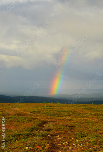 Kaunispää Saariselkä Finland. After the thunder, the sun shines again and a rainbow appears against the dark sky