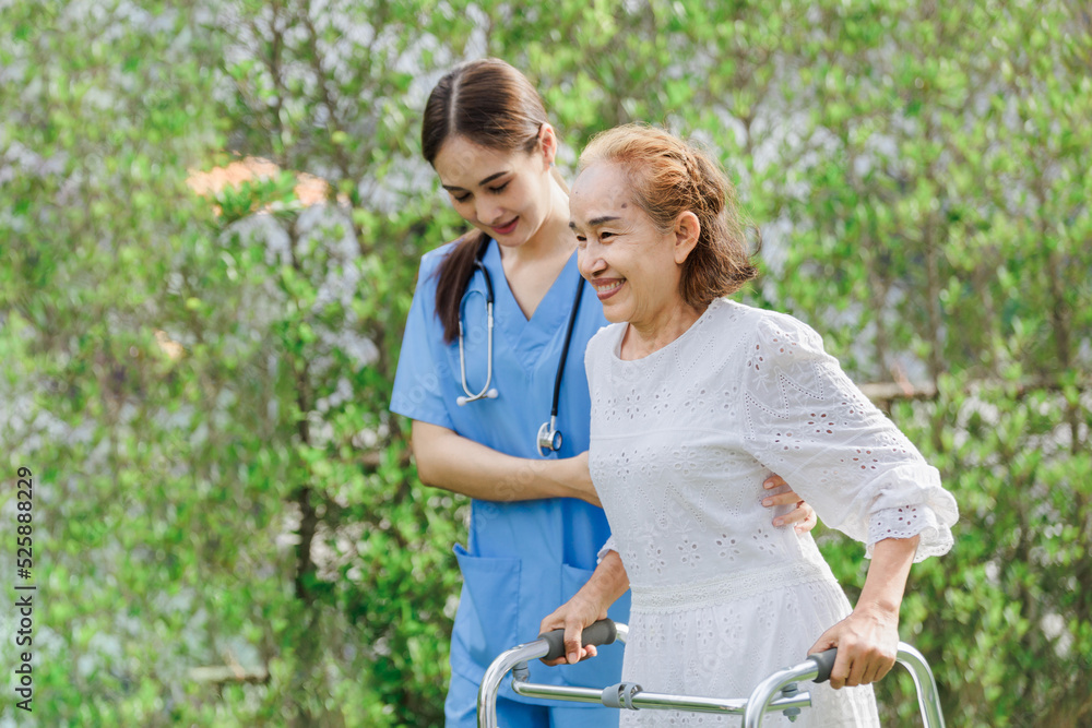 Asian young woman nurse at nursing home take care, patient and woman nurse walk in the park, man caregiver helping patient, Happiness Asian family concepts Asian young woman nurse at nursing home take care, patient and woman nurse walk in the park, man caregiver helping patient, Happiness Asian family concepts
