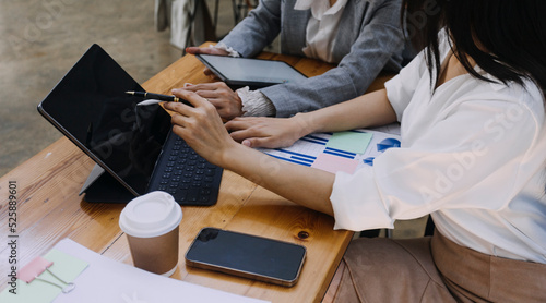 Business team finance or bookkeeper working with a calculator to calculate business data summary report, accountancy document and laptop computer at the office, business meeting concept