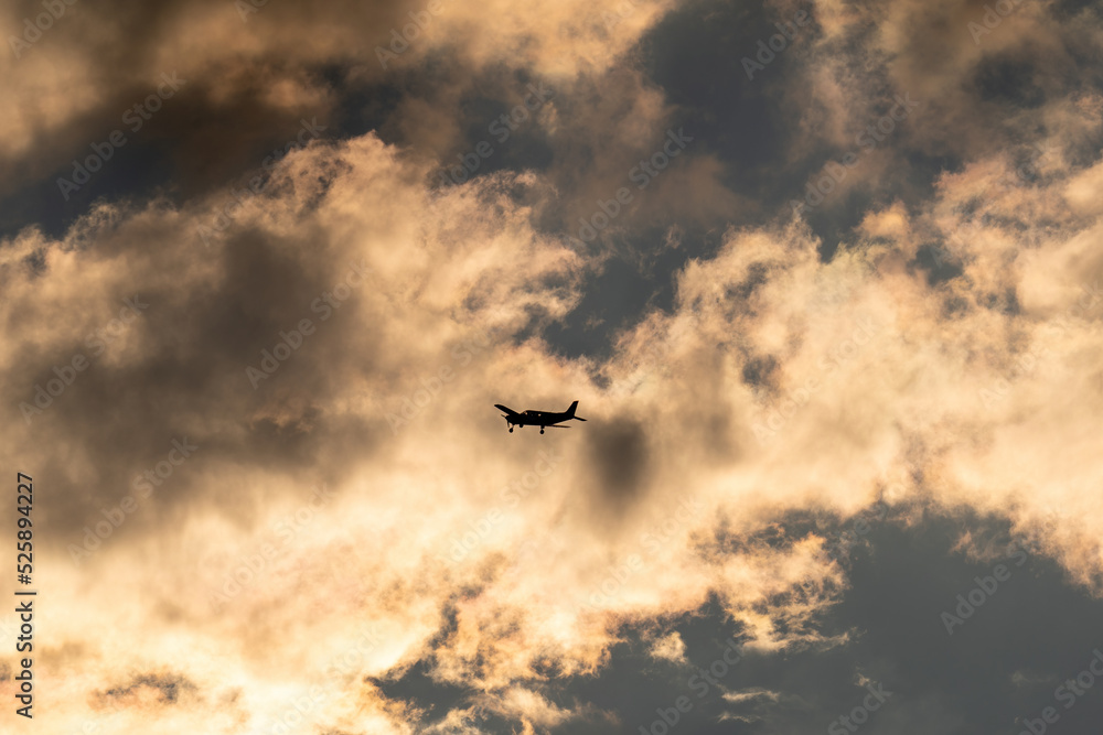 the silhouette of a propeller airplane on the evening sky the silhouette of a propeller airplane on the evening sky