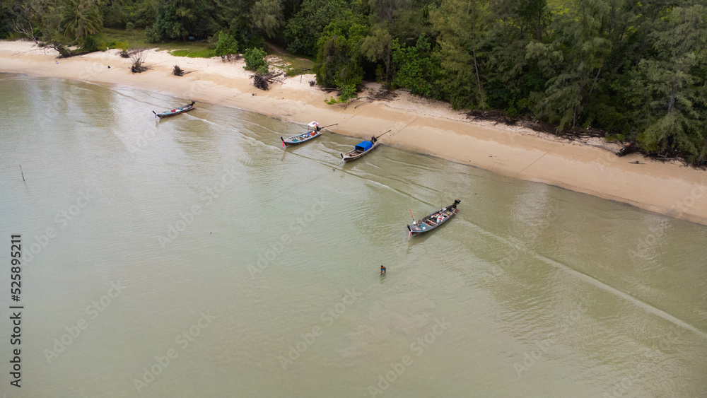 Many fishing boats near the seashore in tropical islands. Pier of the villagers on the southern island of Thailand. top view from drones.