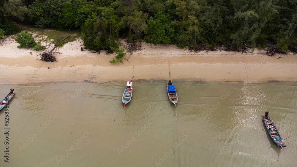Many fishing boats near the seashore in tropical islands. Pier of the villagers on the southern island of Thailand. top view from drones. Many fishing boats near the seashore in tropical islands. Pier of the villagers on the southern island of Thailand. top view from drones.
