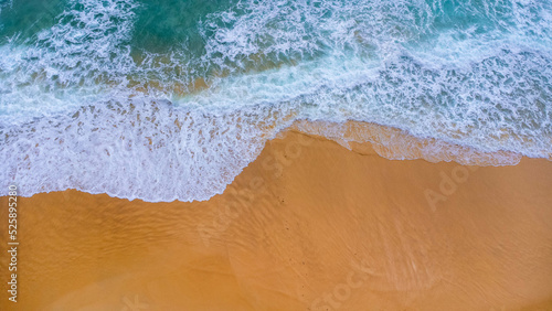Beautiful sea waves and white sand beach in the tropical island. Soft waves of blue ocean on sandy beach background from top view from drones. Concept of relaxation and travel on vacation. © scentrio