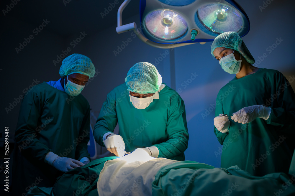 Group of mixed-races professional surgeons operating in hospital operating room , health care concept. Group of mixed-races professional surgeons operating in hospital operating room , health care concept.