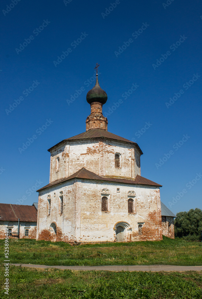 SUZDAL, Vladimir Region, Russia - August, 18, 2022: ancient white-stone Holy Cross Church on the grass on a bright sunny summer day SUZDAL, Vladimir Region, Russia - August, 18, 2022: ancient white-stone Holy Cross Church on the grass on a bright sunny summer day