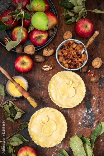Making rustic American style apple pie, top view on table with ingredients 