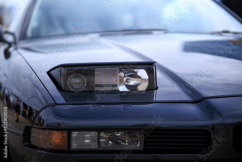 retractable headlight close-up on a blue sports car © Евгений Бордовский