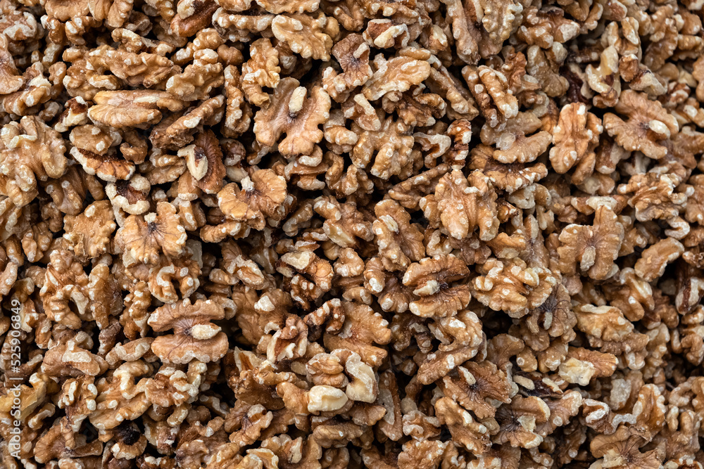 Pile of peeled raw walnut kernels, close up, background.
