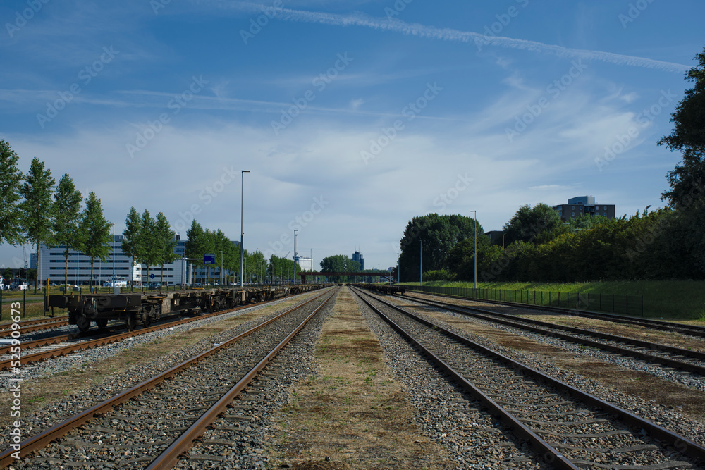 Rotterdam, The Netherlands. Low angle view of long line of freight trains on tracks in the port of rotterdam